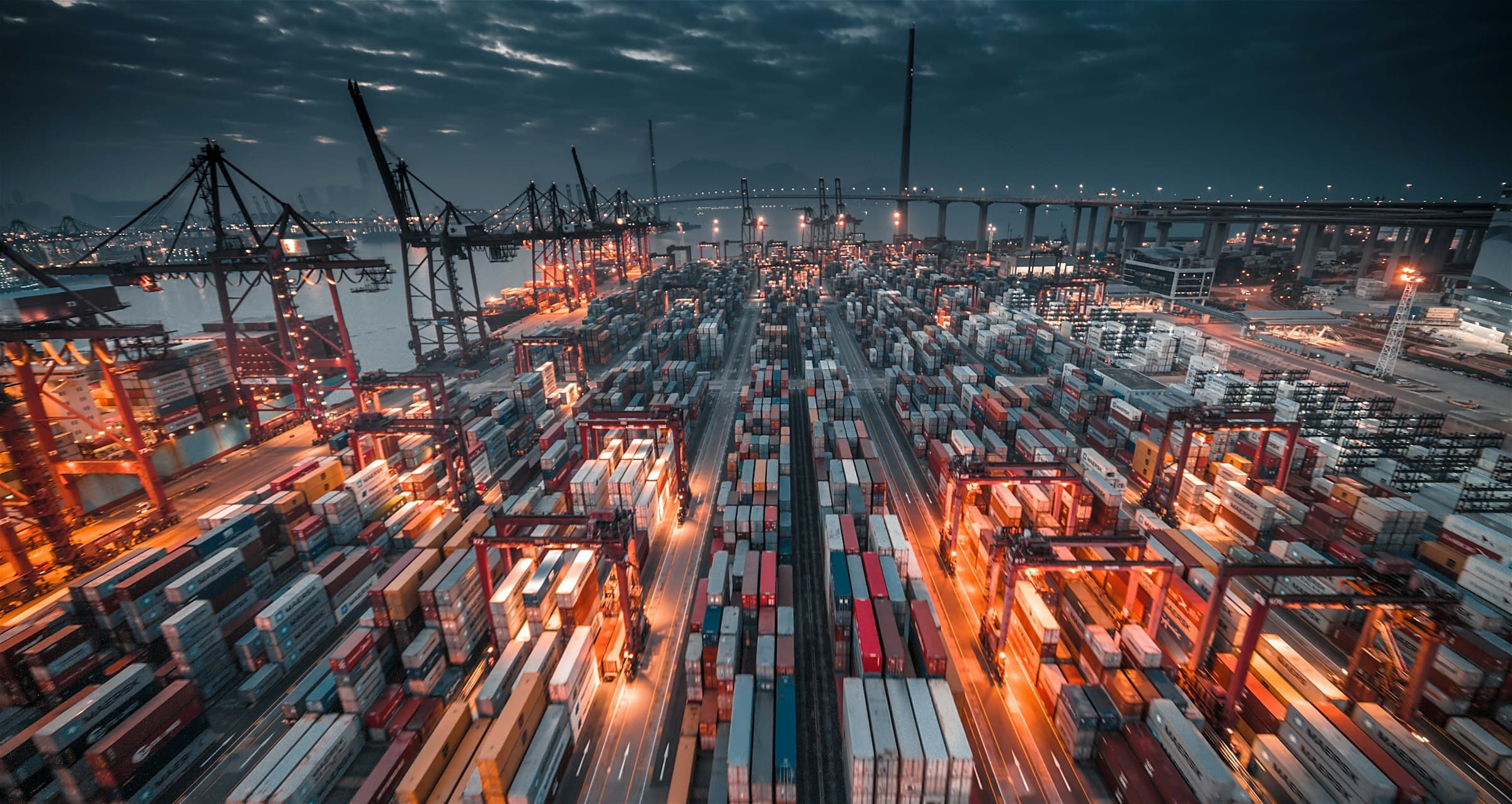 Cranes and containers at a port at dusk